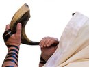 Man blowing Shofar horn
